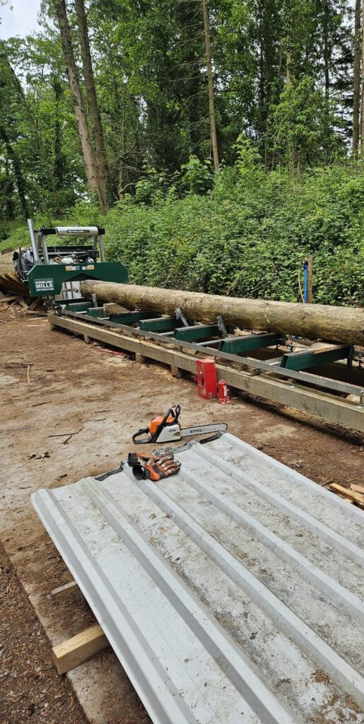Woodland Mills sawmill processing a whole log into timber at Tree Tops and Train Tracks in North Wales